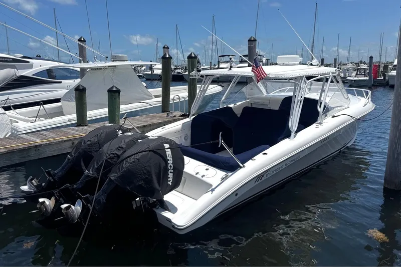 Slide: The Image of 2008 Midnight Express 37 Cabin boat docked with twin Mercury engines, marina background. - 2
