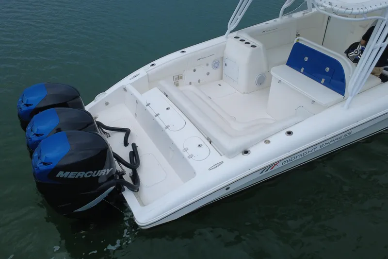 Slide: The Image of 2008 Midnight Express 37 Cabin boat with triple Mercury outboard engines on calm water. - 23