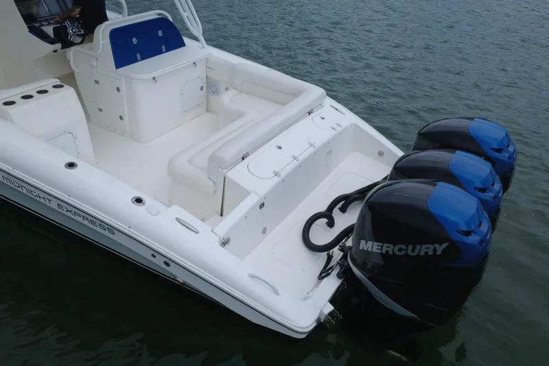 Slide: The Image of 2008 Midnight Express 37 Cabin boat with triple Mercury outboard engines on water. - 24