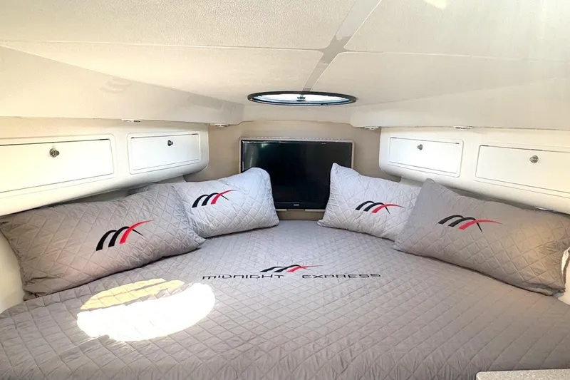 Slide: The Image of Luxurious cabin interior of 2008 Midnight Express 37, featuring cozy bedding and modern amenities. - 7