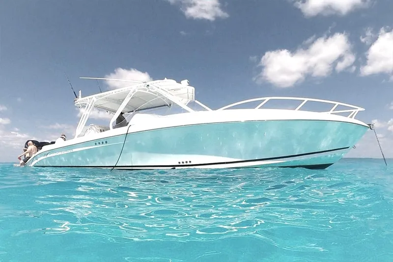 Slide: The Image of 2008 Midnight Express 37 Cabin boat on clear turquoise water under blue sky. - 8