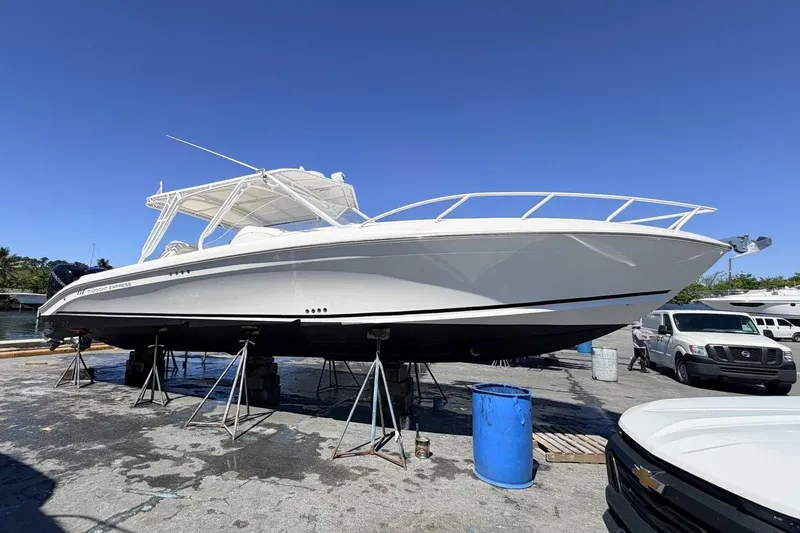 Slide: The Image of 2008 Midnight Express 37 Cabin boat on stands under clear blue sky. - 9