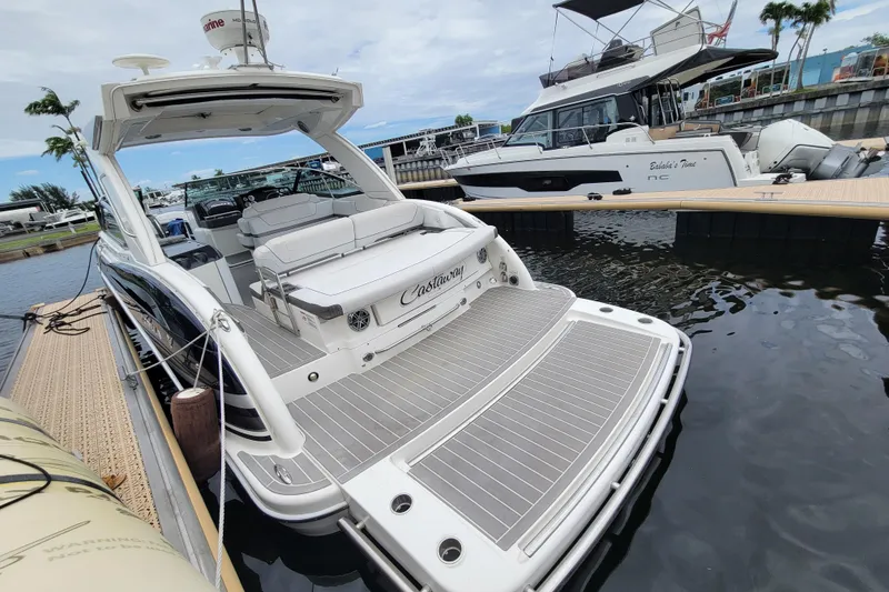 Slide: The Image of 2019 Formula 350 Crossover Bowrider docked, showcasing spacious deck and luxurious seating. - 2