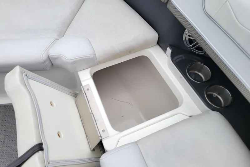 Slide: The Image of 2019 Formula 350 Crossover Bowrider storage compartment with cup holders and cushioned seating. - 30