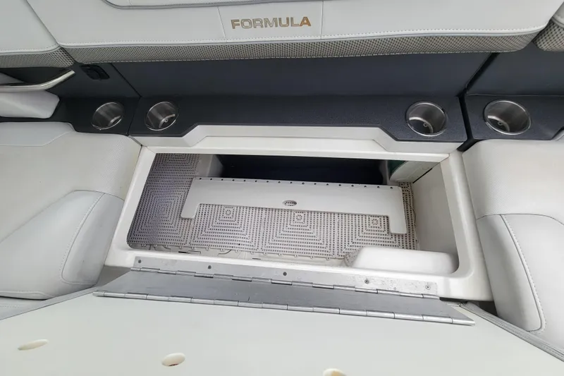 Slide: The Image of 2019 Formula 350 Crossover Bowrider storage compartment with cup holders and seating. - 32