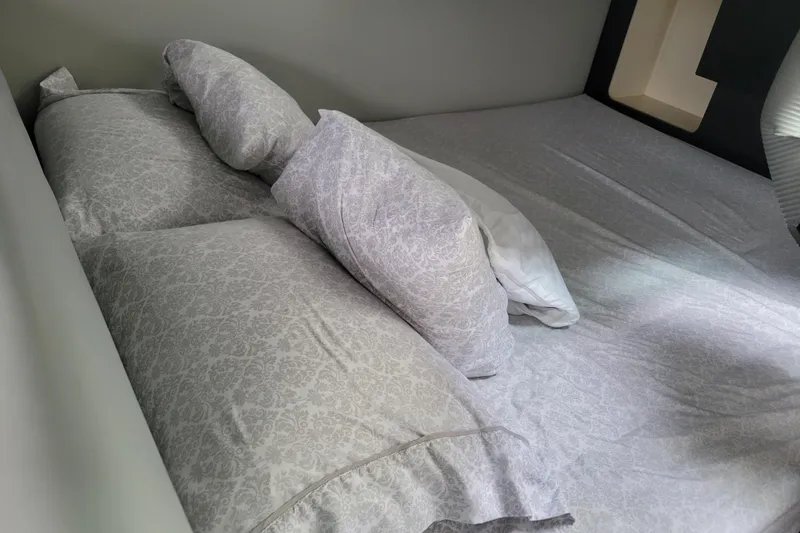 Slide: The Image of Cozy bed with patterned sheets inside a 2019 Formula 350 Crossover Bowrider cabin. - 35