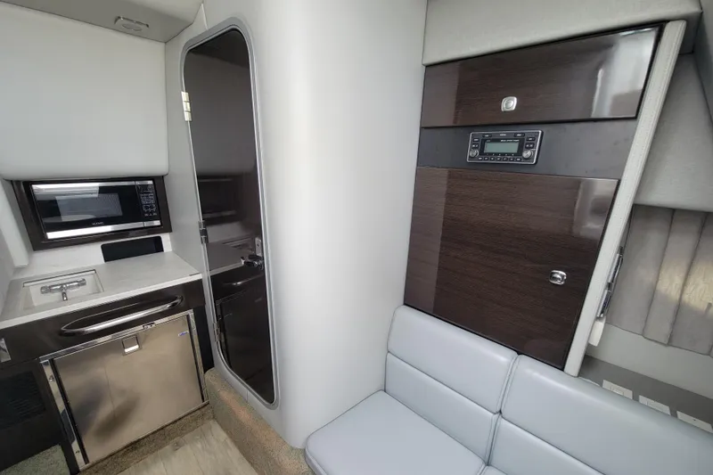 Slide: The Image of Interior of 2019 Formula 350 Crossover Bowrider with kitchenette and seating area. - 38