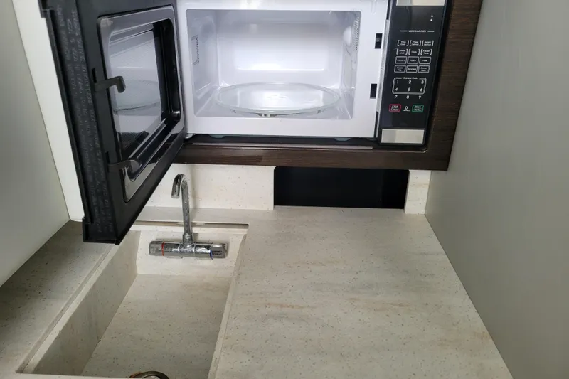 Slide: The Image of Compact kitchenette with microwave and sink in 2019 Formula 350 Crossover Bowrider. - 39