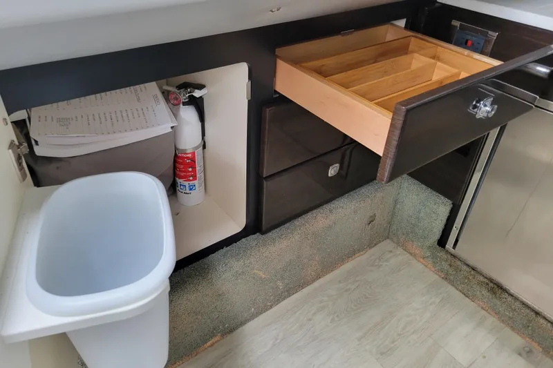 Slide: The Image of Interior of 2019 Formula 350 Crossover Bowrider with open drawer and fire extinguisher. - 41