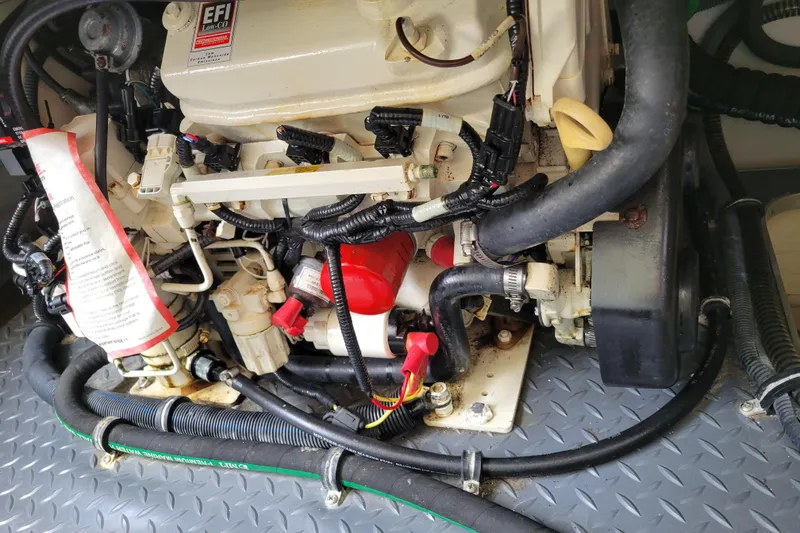 Slide: The Image of Engine compartment of a 2019 Formula 350 Crossover Bowrider with visible wiring and hoses. - 46