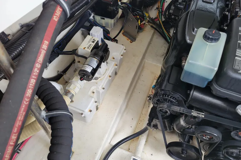 Slide: The Image of Engine compartment of a 2019 Formula 350 Crossover Bowrider, showcasing mechanical components and wiring. - 49