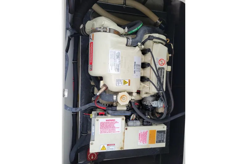 Slide: The Image of Engine compartment of a 2019 Formula 350 Crossover Bowrider boat, showcasing mechanical components. - 53