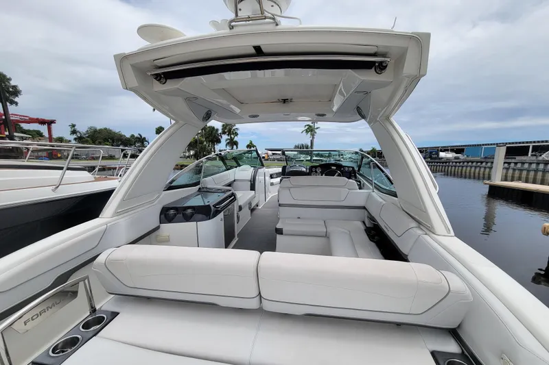 Slide: The Image of 2019 Formula 350 Crossover Bowrider with spacious seating and sleek design docked at marina. - 9