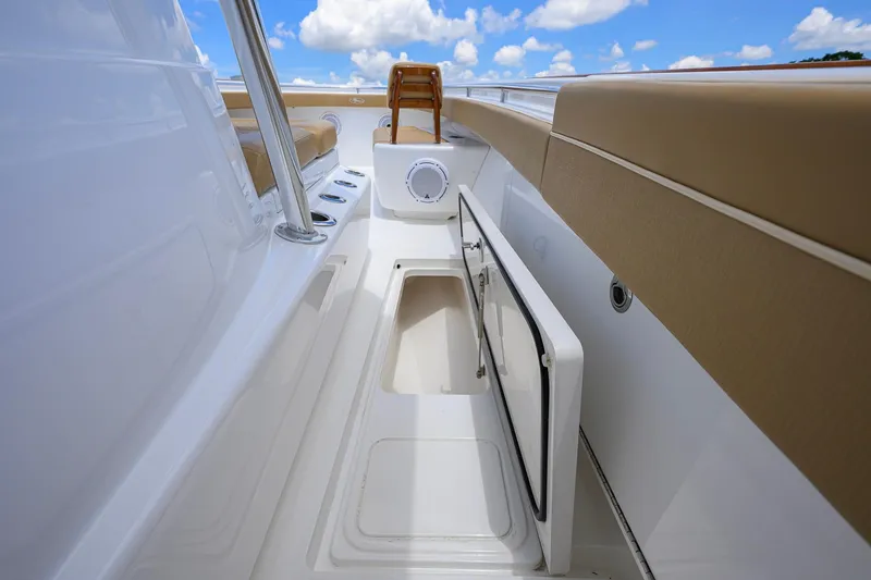 Slide: The Image of 2023 Valhalla Boatworks V-37 interior with storage compartment and seating, under blue sky. - 34