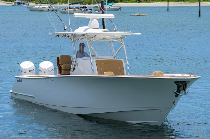 Slide: The Image of 2023 Valhalla Boatworks V-37 cruising on calm waters, featuring twin outboard engines. - 2