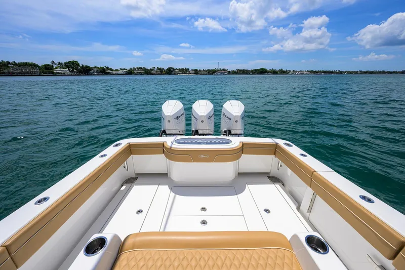 Slide: The Image of 2023 Valhalla Boatworks V-37 with triple engines on open water under blue sky. - 37