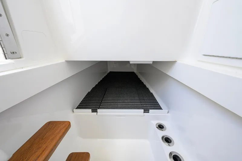 Slide: The Image of Interior view of 2023 Valhalla Boatworks V-37, featuring sleek white design and wooden steps. - 61