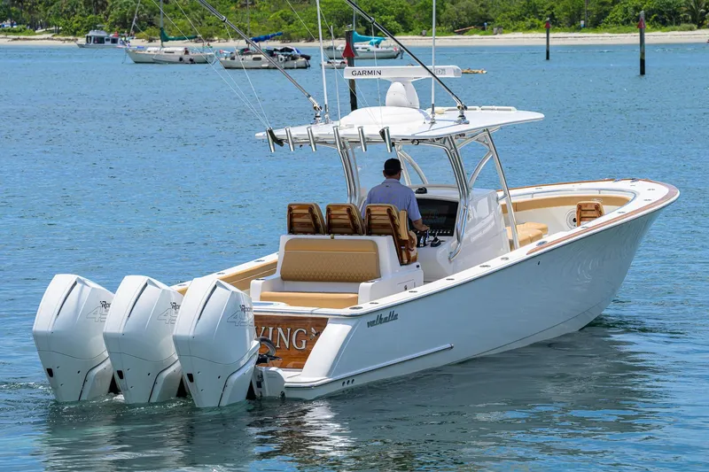 Slide: The Image of 2023 Valhalla Boatworks V-37 cruising on water with triple outboard engines. - 9