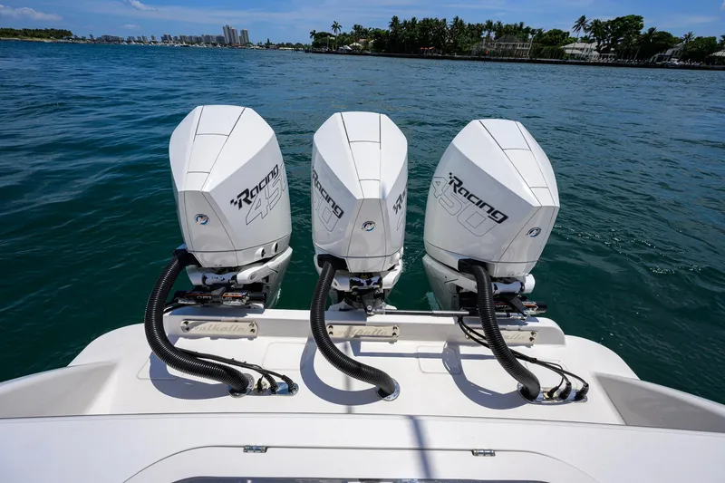 Slide: The Image of Triple Mercury Racing 450 engines on 2023 Valhalla Boatworks V-37, cruising on blue waters. - 54