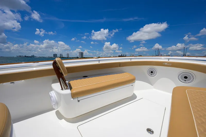 Slide: The Image of 2023 Valhalla Boatworks V-37 interior with tan seating, ocean view, and blue sky. - 27