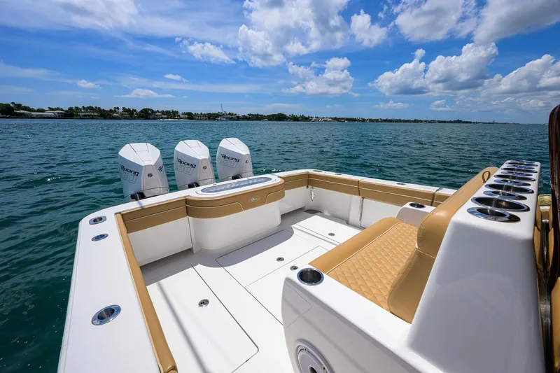 Slide: The Image of 2023 Valhalla Boatworks V-37 on water, featuring triple outboard engines and luxurious seating. - 35