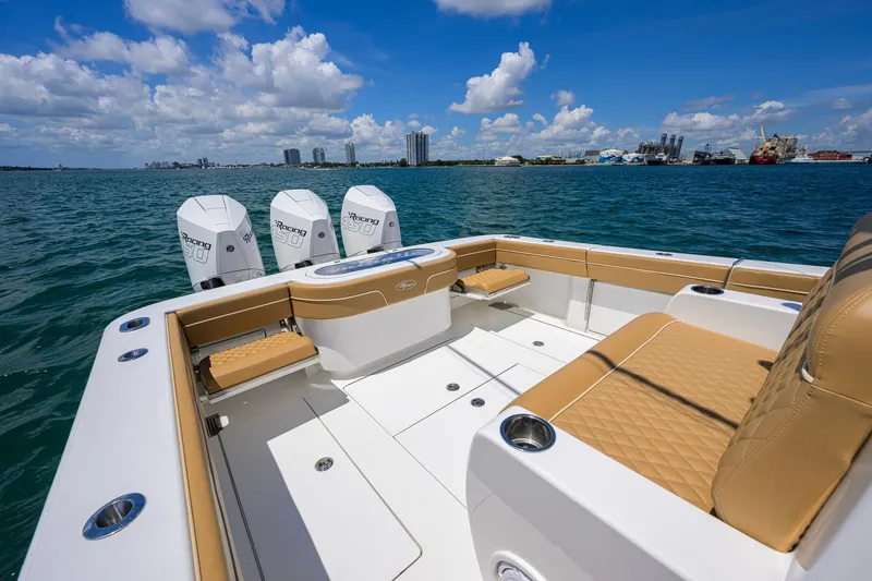 Slide: The Image of 2023 Valhalla Boatworks V-37 on water, featuring triple outboard engines and luxurious seating. - 36