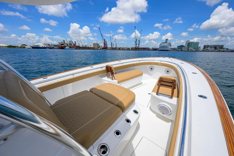 Slide: The Image of 2023 Valhalla Boatworks V-37 luxury boat interior with tan seating, dockside view. - 32