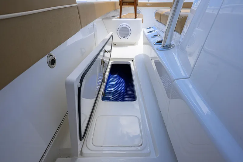 Slide: The Image of 2023 Valhalla Boatworks V-37 interior with open storage compartment and seating. - 22