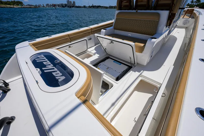 Slide: The Image of 2023 Valhalla Boatworks V-37 interior with open storage compartments, showcasing luxury and functionality. - 44