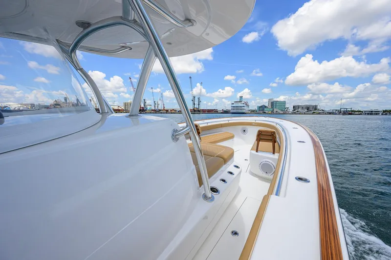 Slide: The Image of 2023 Valhalla Boatworks V-37 cruising in a harbor under a blue sky. - 33
