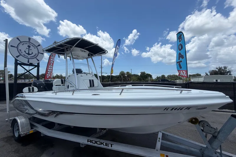 The Image of 2012 Glasstream 221 CC boat on trailer, displayed outdoors with sale banners. - 0