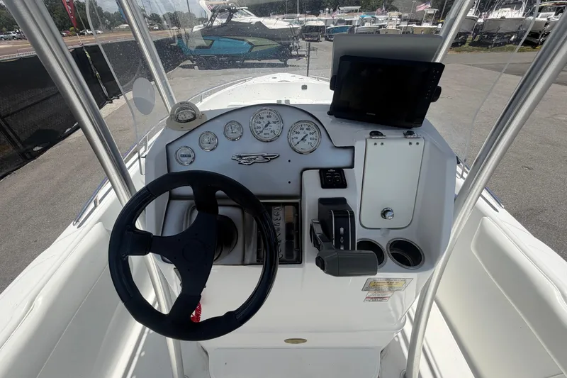 Slide: The Image of 2012 Glasstream 221 CC boat dashboard with steering wheel and gauges. - 16