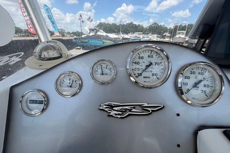 Slide: The Image of Dashboard of a 2012 Glasstream 221 CC boat with gauges and compass. - 18