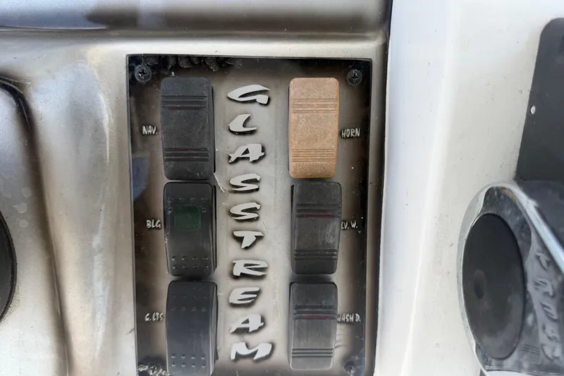 Slide: The Image of Control panel of a 2012 Glasstream 221 CC boat with labeled switches. - 19