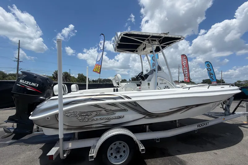 Slide: The Image of 2012 Glasstream 221 CC boat on trailer with Suzuki outboard motor, under a clear blue sky. - 2