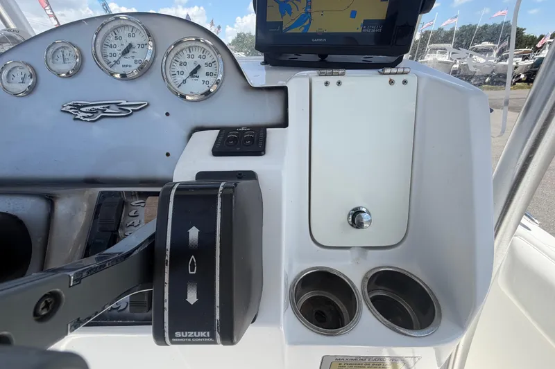 Slide: The Image of 2012 Glasstream 221 CC boat dashboard with Suzuki controls and Garmin navigation system. - 21