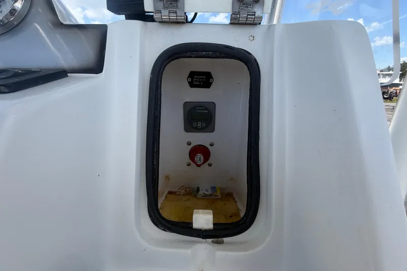 Slide: The Image of Control panel of a 2012 Glasstream 221 CC boat, featuring gauges and switches. - 22