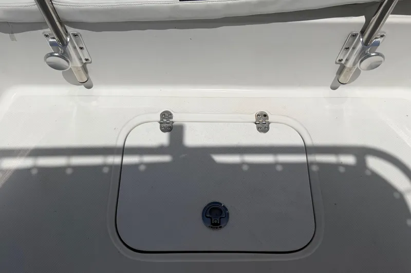 Slide: The Image of A white boat deck with a closed hatch and two metal brackets. - 26