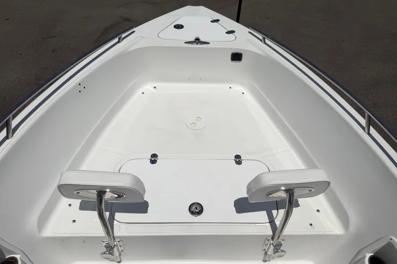 Slide: The Image of Bow seating area of a 2012 Glasstream 221 CC boat, featuring white cushioned seats. - 28