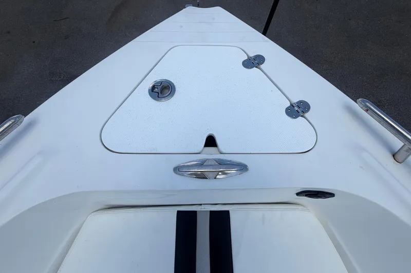Slide: The Image of The boat features a white deck with a closed compartment and metal fittings. - 32