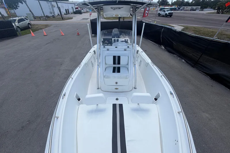 Slide: The Image of 2012 Glasstream 221 CC boat with white deck and black stripes, parked outdoors. - 35
