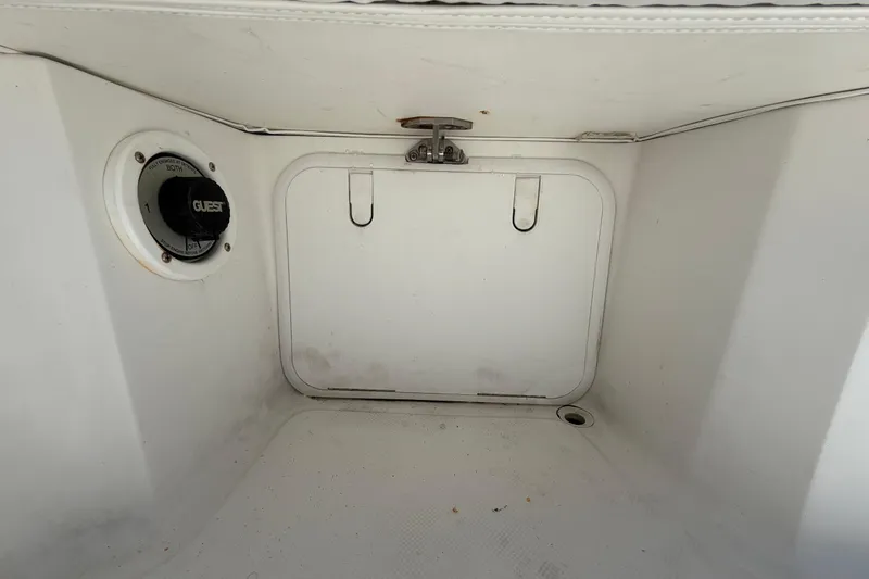 Slide: The Image of 2012 Glasstream 221 CC boat storage compartment with battery switch and drainage. - 50