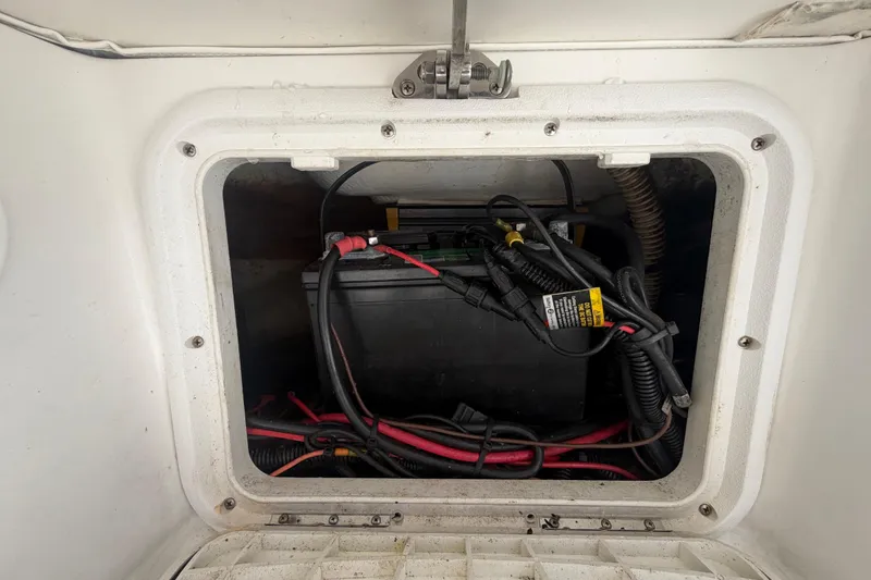 Slide: The Image of Battery compartment of a 2012 Glasstream 221 CC boat with wiring and connections. - 51