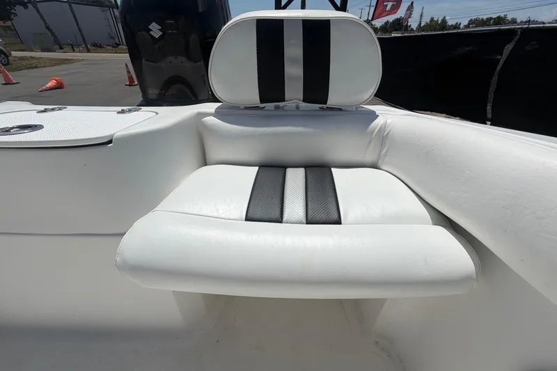 Slide: The Image of 2012 Glasstream 221 CC boat seat with black and white upholstery, outdoor setting. - 54