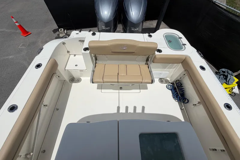 Slide: The Image of 2018 NauticStar 28 XS boat interior with seating and twin engines. - 67