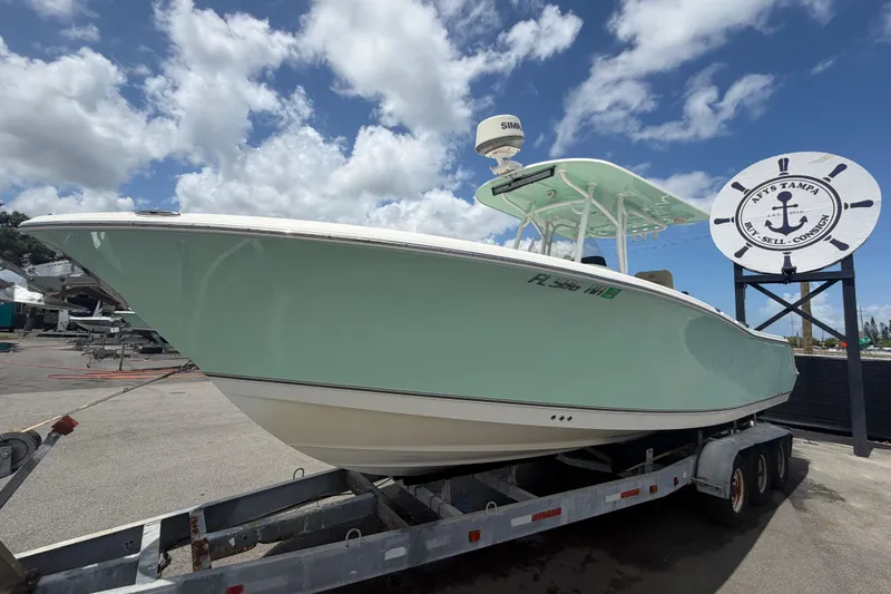 Slide: The Image of 2018 NauticStar 28 XS boat on trailer under blue sky at Tampa dealership. - 13