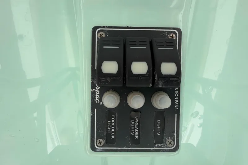 Slide: The Image of Control panel on a 2018 NauticStar 28 XS boat with light switches. - 36