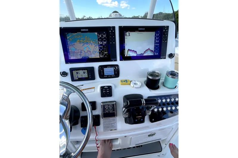 Slide: The Image of Helm of 2018 NauticStar 28 XS with dual Simrad displays and Yamaha controls. - 2