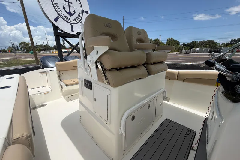 Slide: The Image of 2018 NauticStar 28 XS boat interior with beige seating and steering console. - 58
