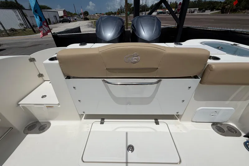 Slide: The Image of 2018 NauticStar 28 XS boat interior with beige seating and dual outboard motors. - 75